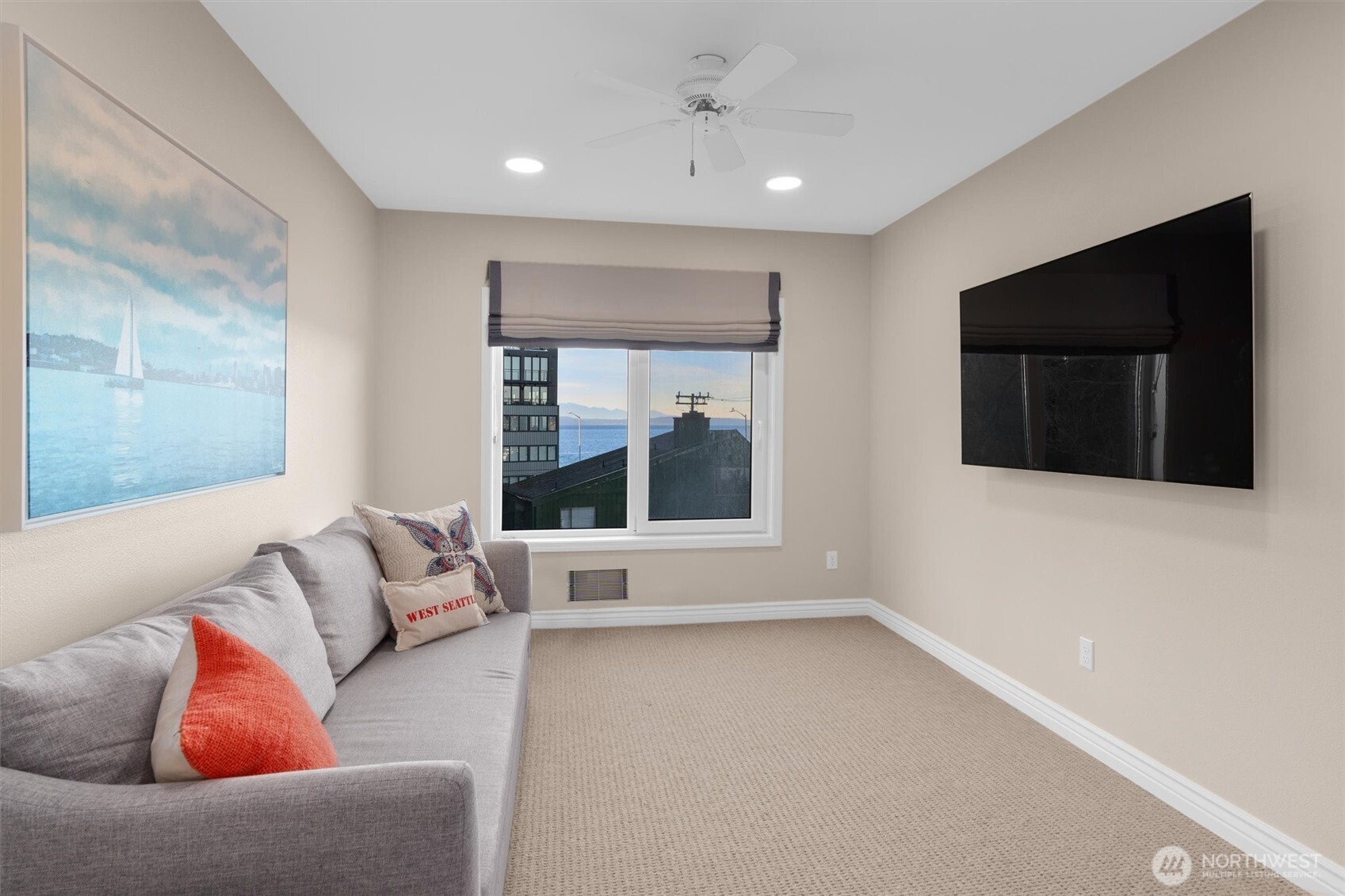 1005 Harbor Avenue Southwest, Unit 400 Seattle, WA 98116 - Photo 19 of 39 a living room with furniture and a flat screen tv