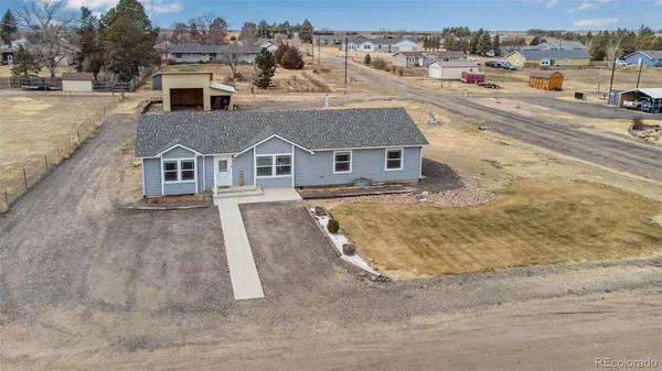 an aerial view of a house with a yard