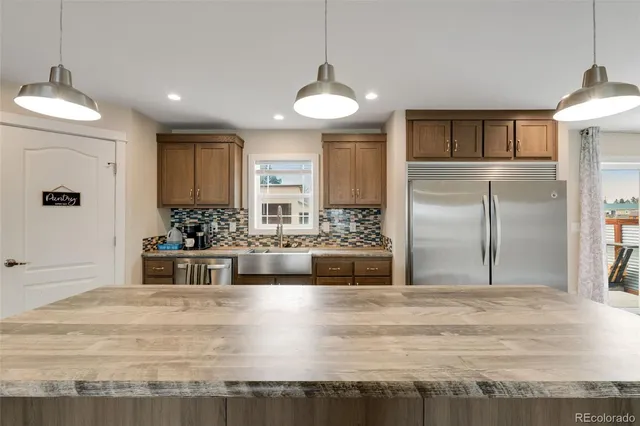 a kitchen with granite countertop a sink and a stove