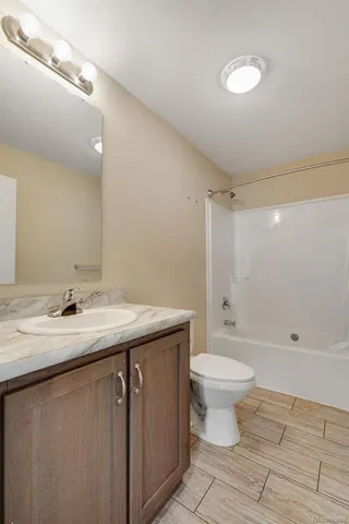 a bedroom with a bed and a potted plant