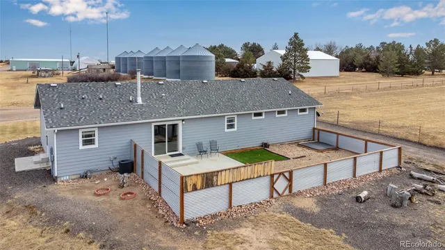 a view of a house with pool and chairs