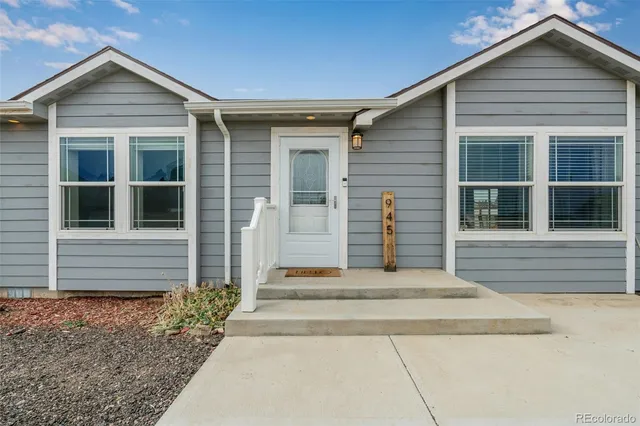 a view of a kitchen with furniture and wooden floor