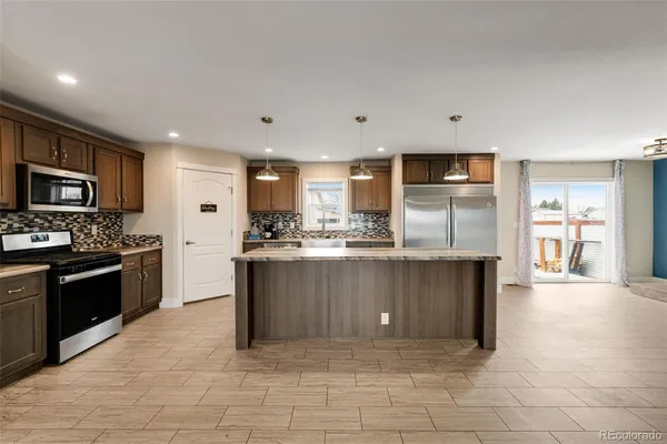 a kitchen with a refrigerator a sink and cabinets