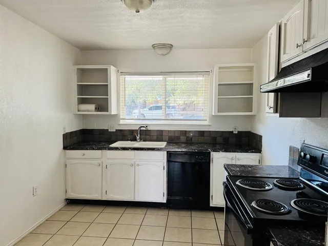 a kitchen with a stove and a sink