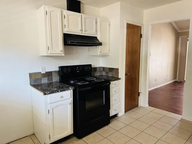 a kitchen with stainless steel appliances granite countertop a stove and a refrigerator