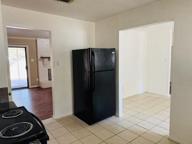 a kitchen with a refrigerator and a stove