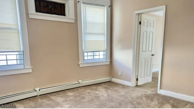 an empty room with a empty space and windows