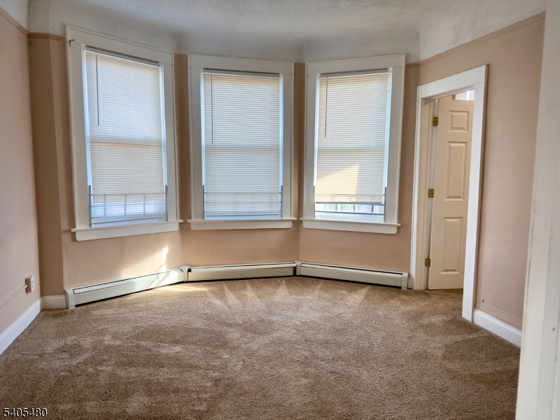 245 22nd Street Irvington, NJ 07111 - Photo 14 of 17 an empty room with a empty space and windows