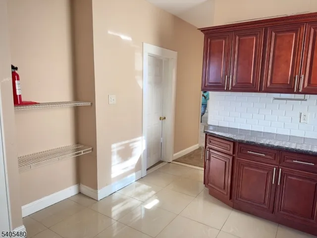 a kitchen with stainless steel appliances granite countertop a refrigerator and a cabinets