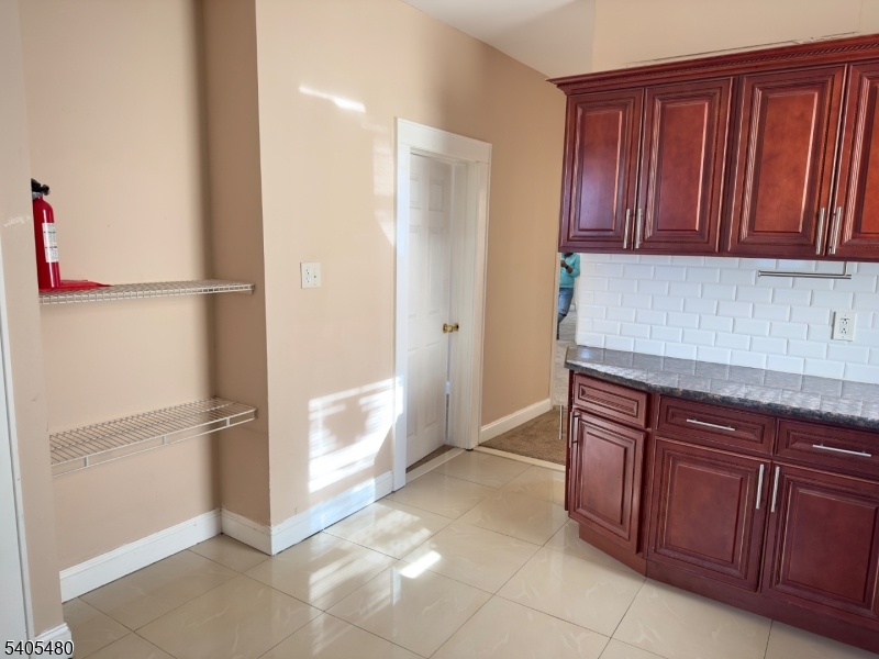 245 22nd Street Irvington, NJ 07111 - Photo 3 of 17 a kitchen with stainless steel appliances granite countertop a refrigerator and a cabinets