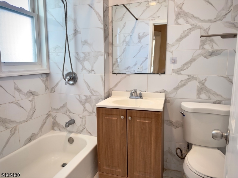 245 22nd Street Irvington, NJ 07111 - Photo 8 of 17 a bathroom with a sink a toilet and bathtub