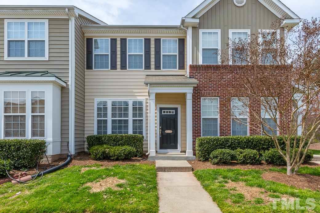7739 Winners Edge Street Raleigh, NC 27617 - Photo 1 of 12 front view of a house next to a yard