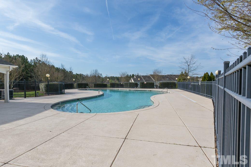 7739 Winners Edge Street Raleigh, NC 27617 - Photo 10 of 12 a view of a swimming pool and a yard
