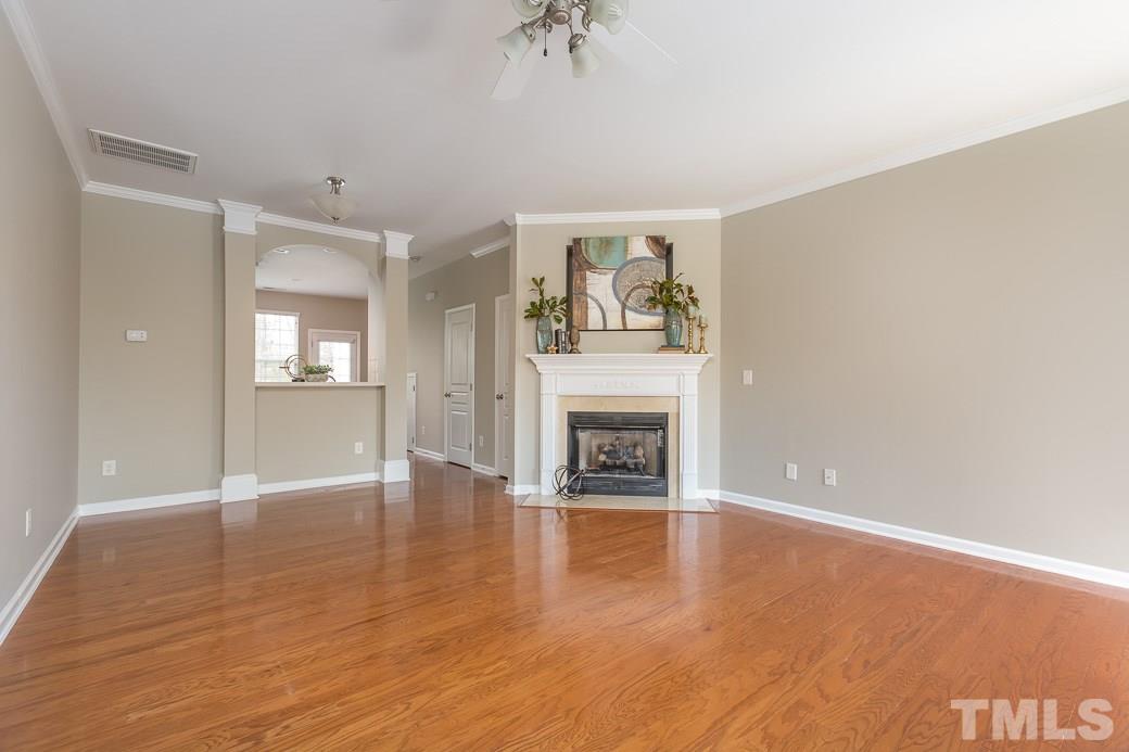 7739 Winners Edge Street Raleigh, NC 27617 - Photo 3 of 12 a view of an empty room with window and fire place