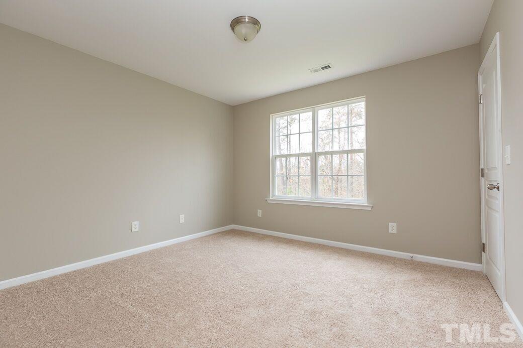 7739 Winners Edge Street Raleigh, NC 27617 - Photo 8 of 12 a view of an empty room with a window