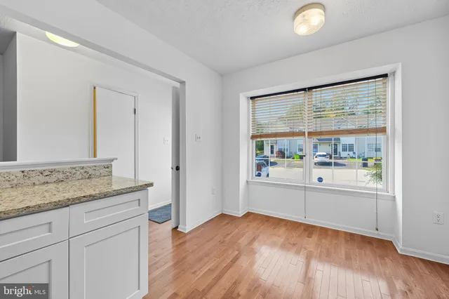 a room with a wooden floor and a large window