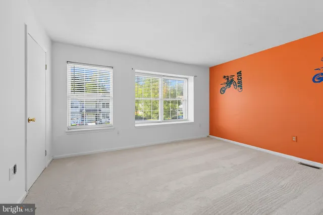 a spacious bathroom with a toilet sink and mirror