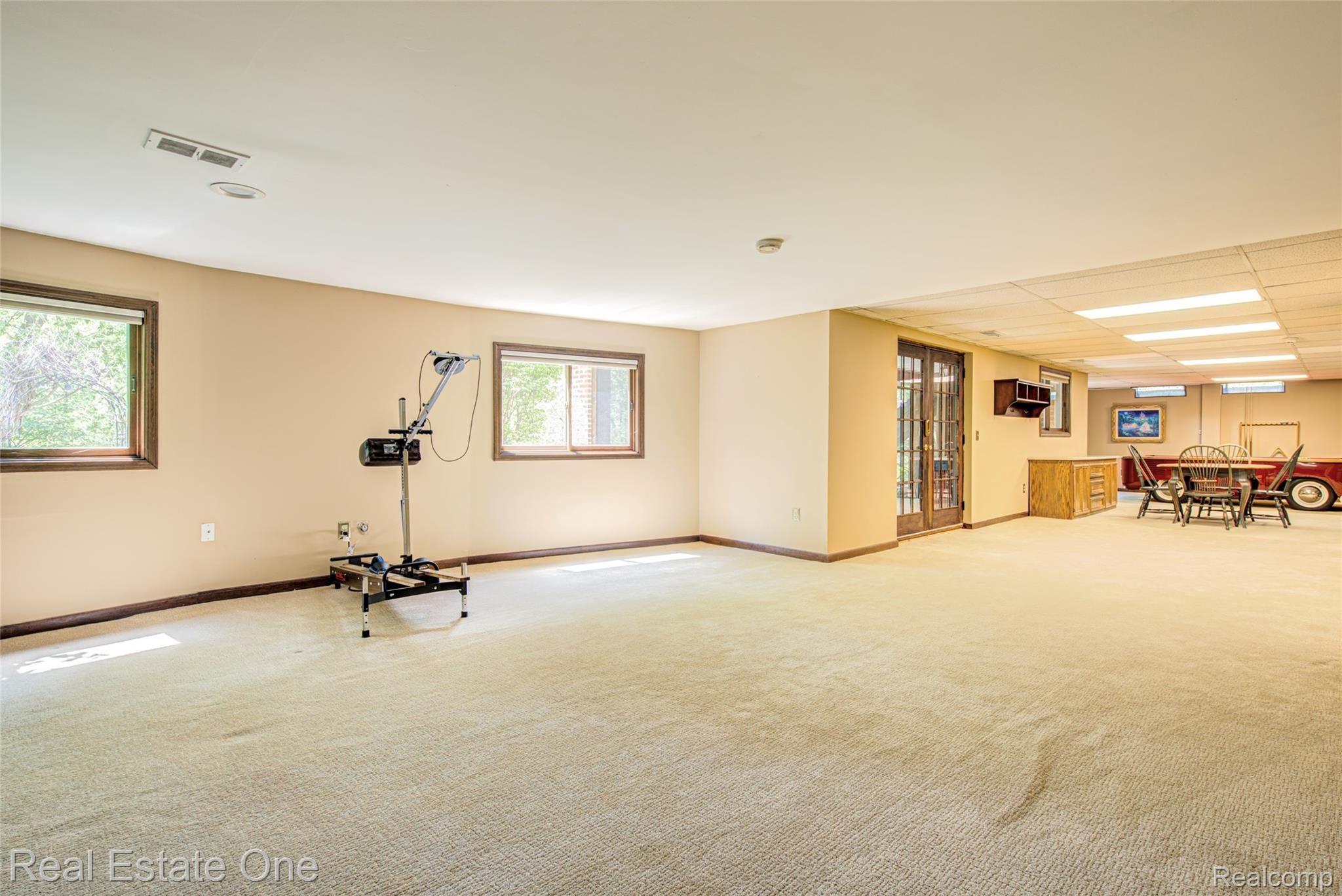 3274 Quail Ridge Circle Rochester, MI 48309 - Photo 58 of 74 Lower level view 2 with French doors that lead to cover screened in patio