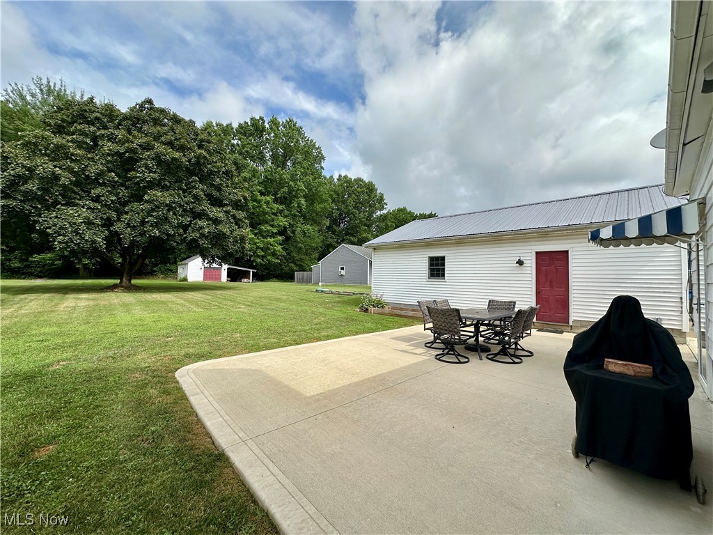 9574 Quarry Road Amherst, OH 44001 - Photo 6 of 31 View of patio / terrace with grilling area, outdoor dining area, and an outdoor structure