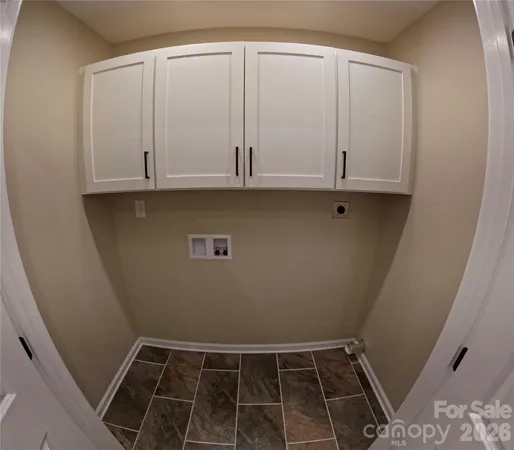 a view of storage and utility room with wooden floor