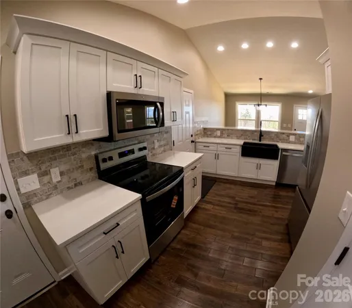 a kitchen with a stove and a microwave