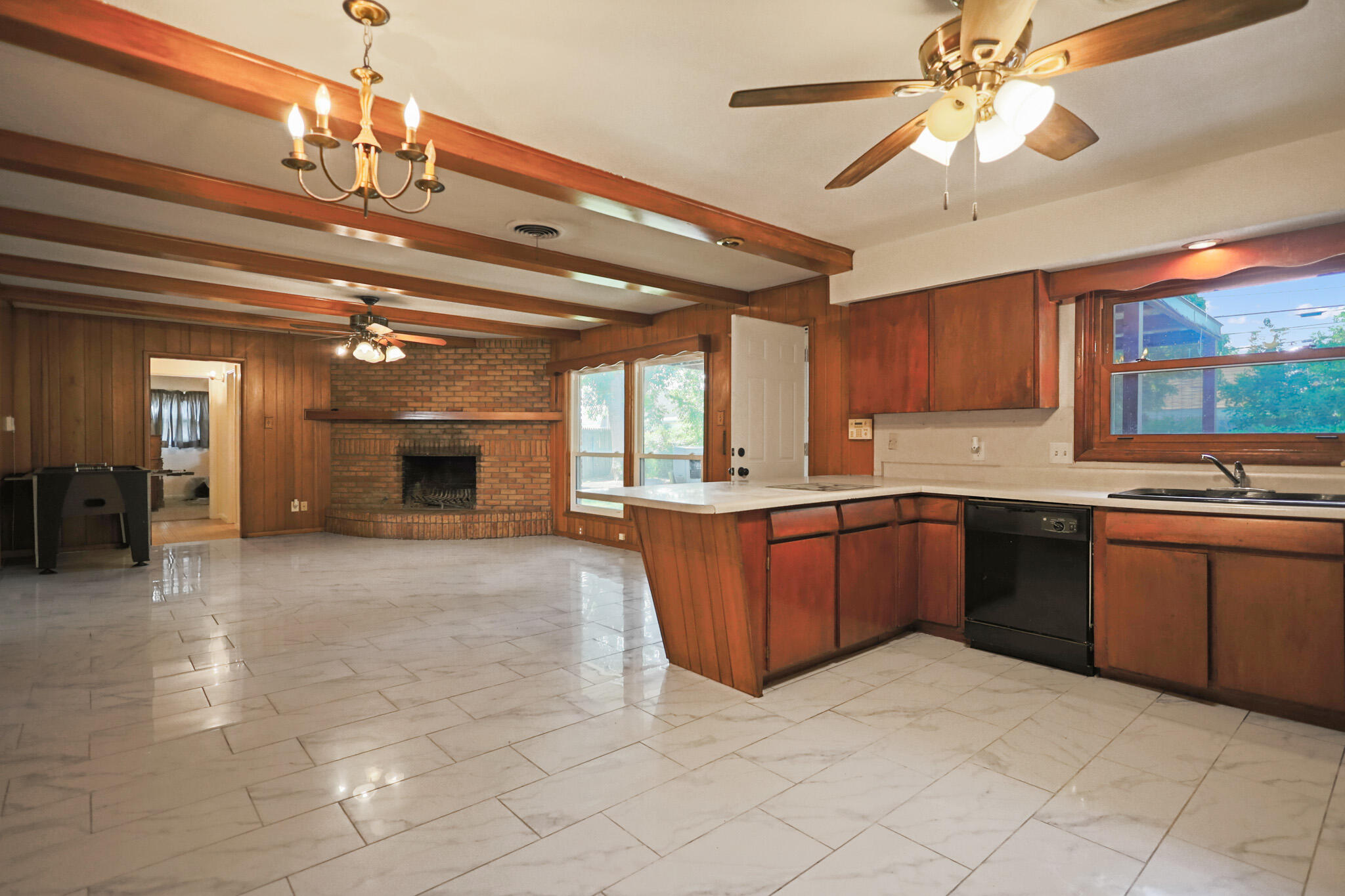 5209 17th Street Lubbock, TX 79416 - Photo 17 of 40 a large kitchen with a large window cabinets and stainless steel appliances