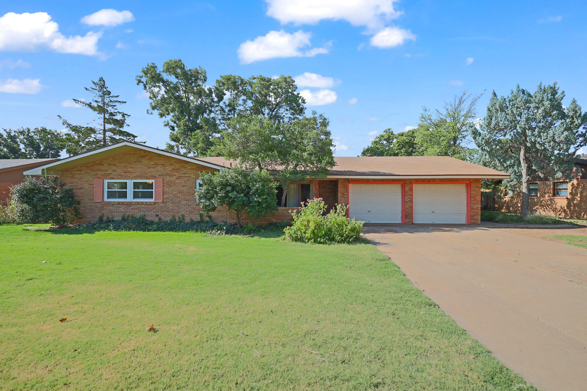 5209 17th Street Lubbock, TX 79416 - Photo 3 of 40 front view of house with a yard and trees