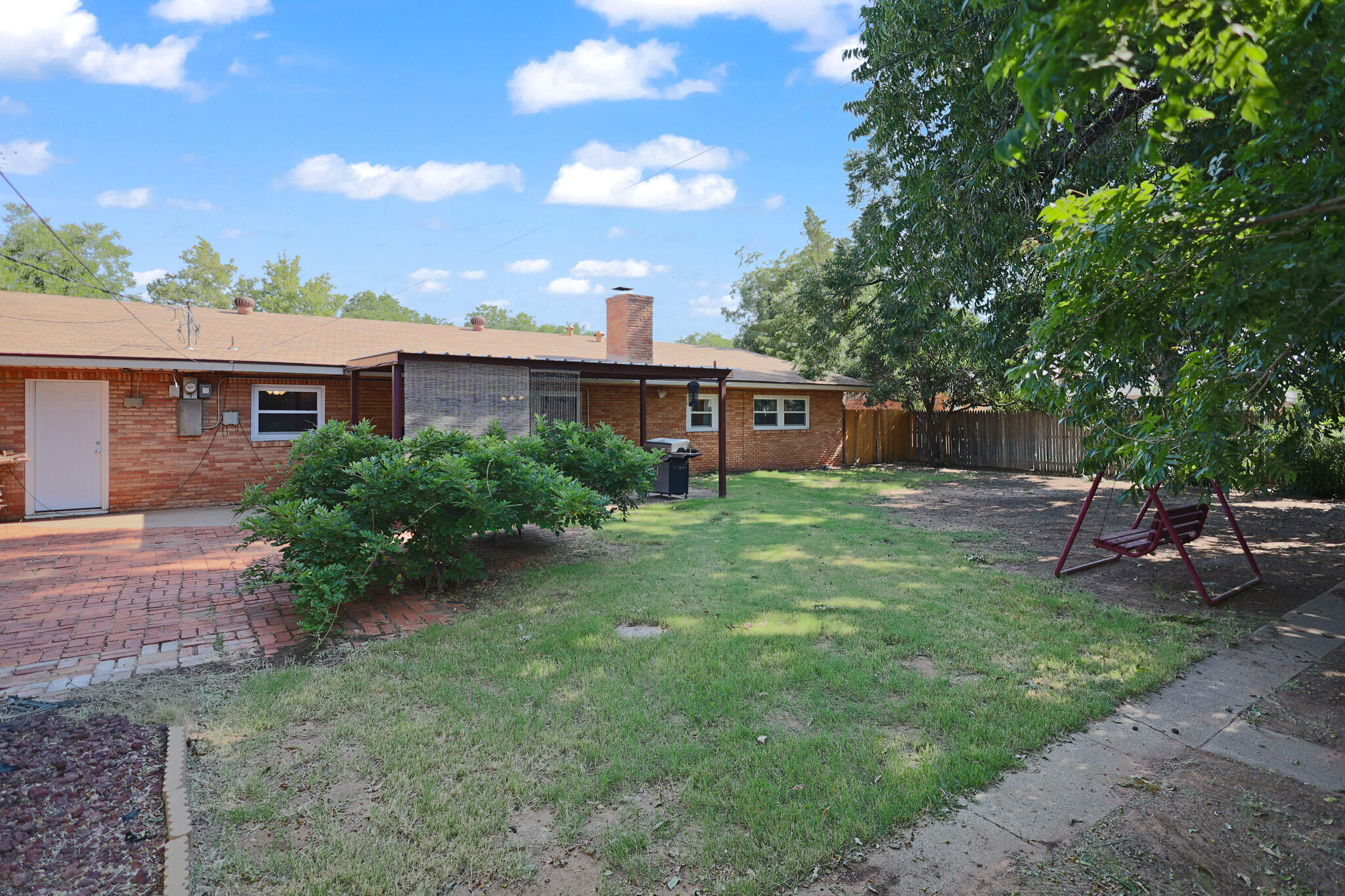 5209 17th Street Lubbock, TX 79416 - Photo 33 of 40 a view of a house with a backyard and a patio