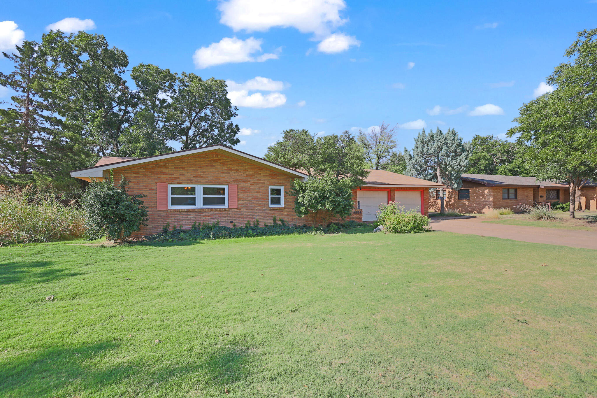 5209 17th Street Lubbock, TX 79416 - Photo 40 of 40 a front view of a house with a garden