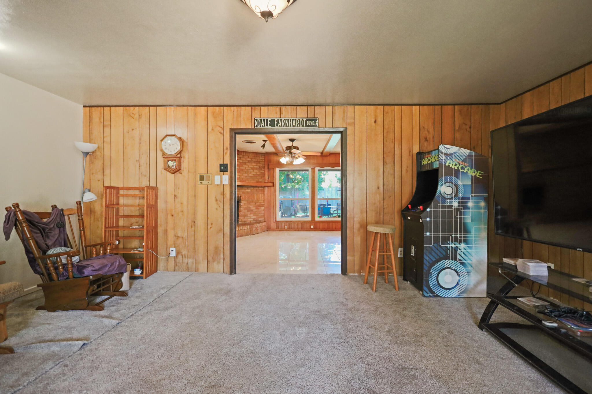 5209 17th Street Lubbock, TX 79416 - Photo 5 of 40 a living room with furniture a flat screen tv and a window