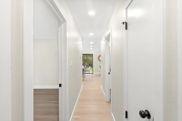 a view of a room with wooden floor and white walls