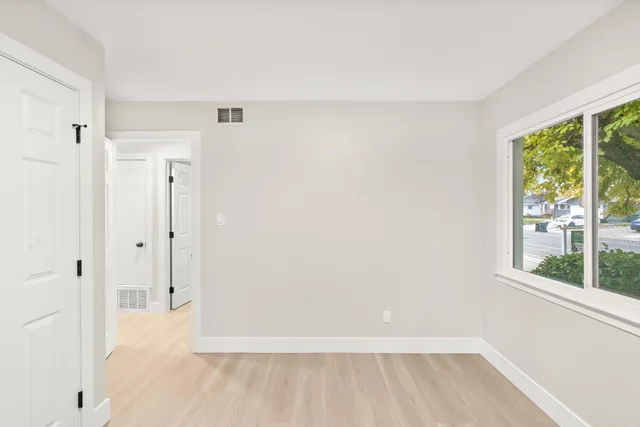 a bedroom with a bed and a night stand