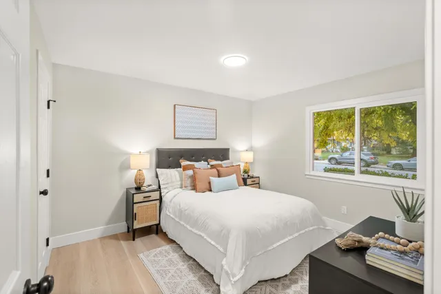 a bedroom with a bed and a window