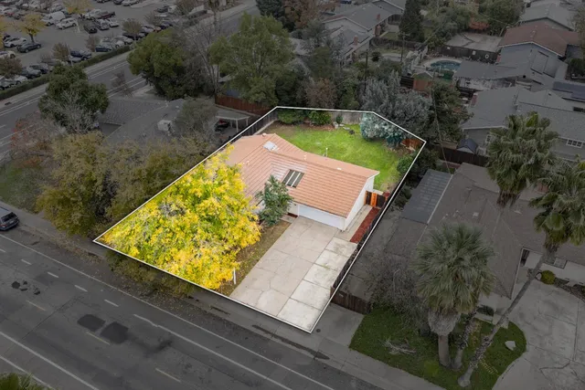 an aerial view of residential houses with outdoor space