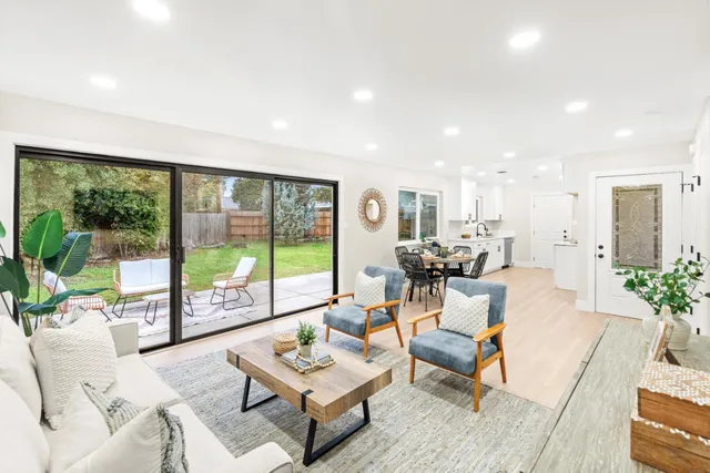 a view of a dining room with furniture and a window