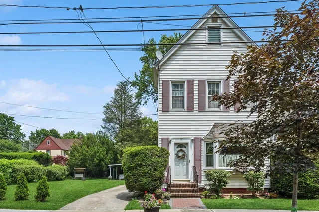a house that has a tree in front of the house
