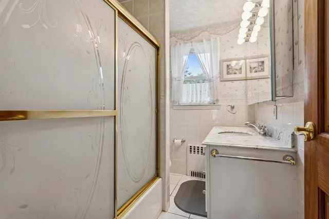 a bathroom with a sink a toilet and a mirror