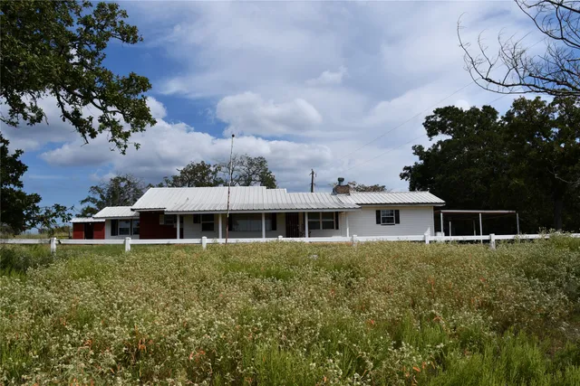 a house with lots of trees in the background