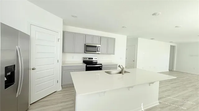 a kitchen with a refrigerator a stove top oven a sink and dishwasher