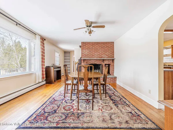 a view of a dining room with furniture window and wooden floor