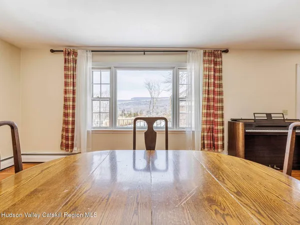 a view of a bedroom with wooden floor and a window