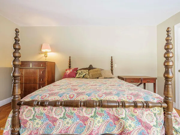 a bedroom with a bed and a mirror