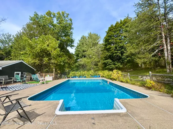 a view of swimming pool with lounge chair