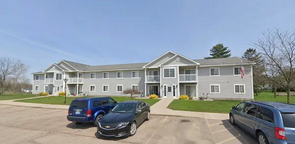 a front view of a house with a garden and yard
