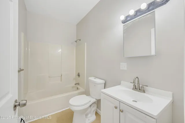 a bathroom with a toilet a sink and bathtub