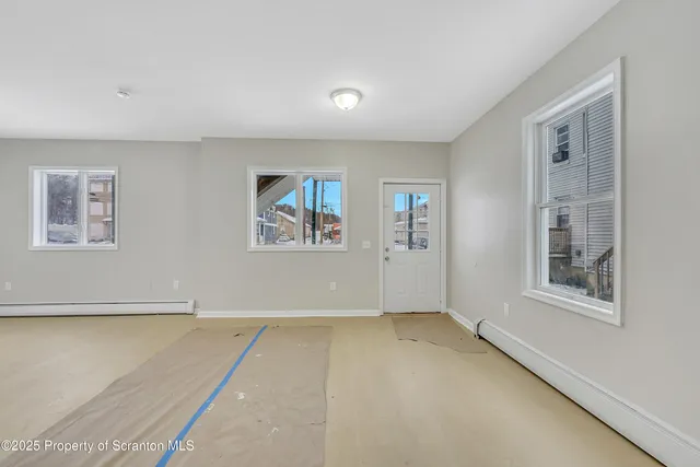 a view of an empty room with a window