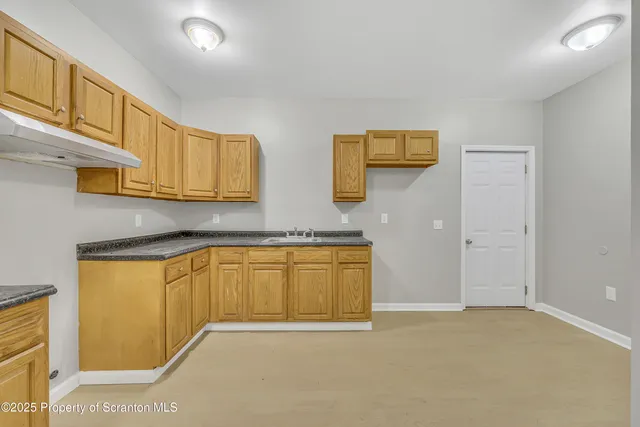 a kitchen with stainless steel appliances granite countertop a sink and cabinets