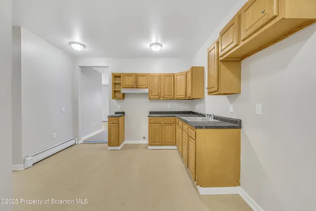 a view of a kitchen with wooden floor