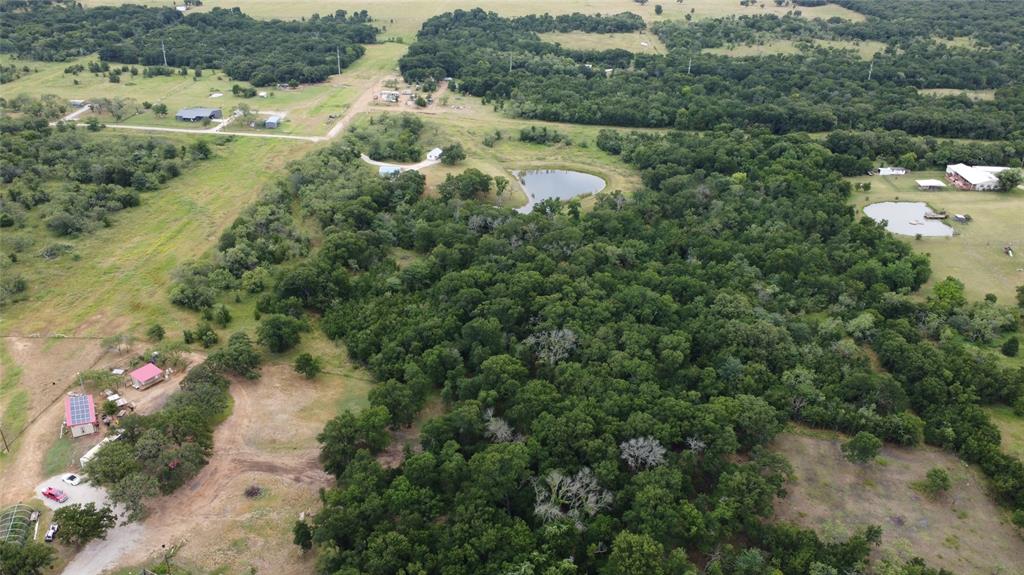 101 Private Road Whitney, TX 76692 - Photo 21 of 30 an aerial view of residential houses with outdoor space and trees