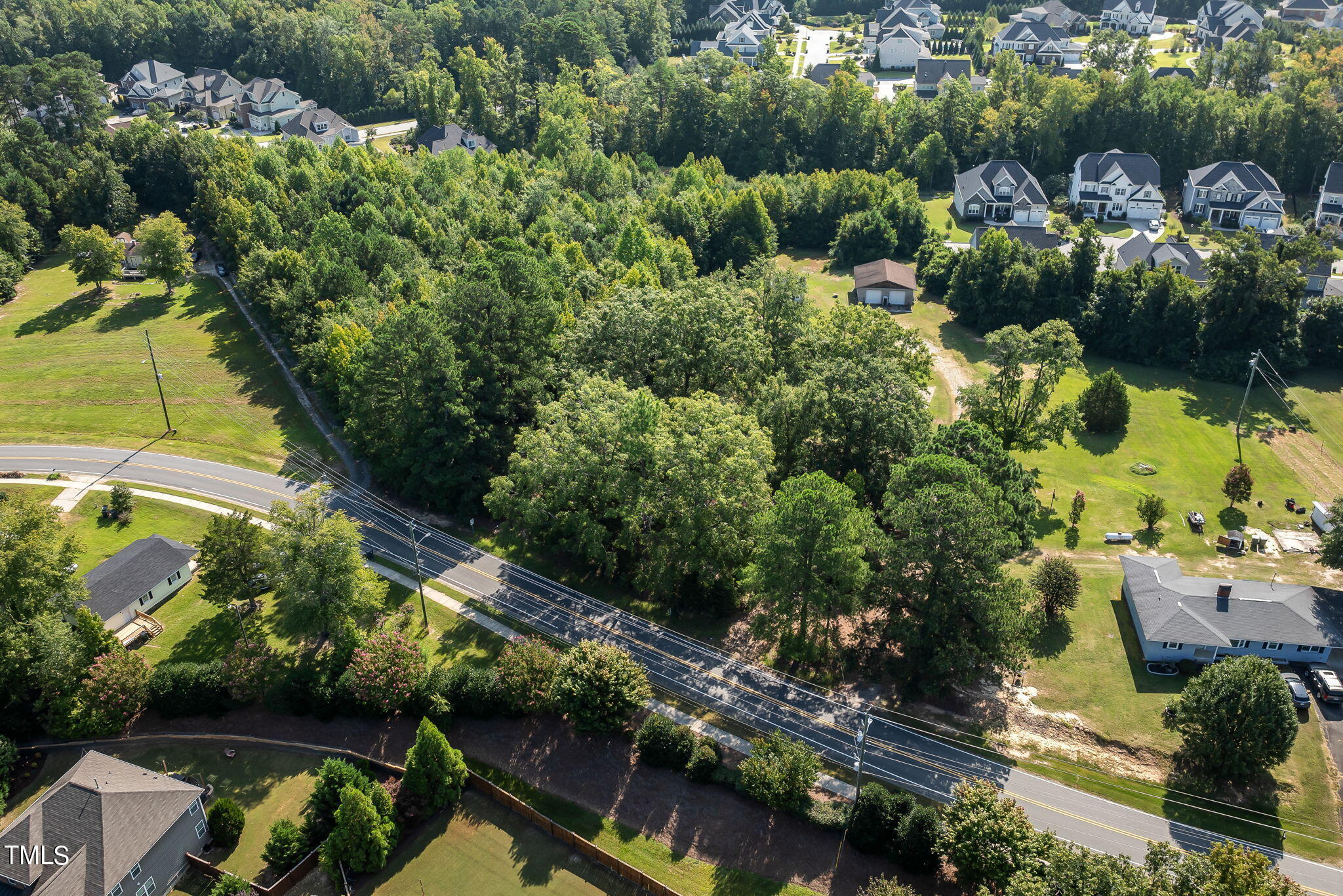 2801 Evans Road Apex, NC 27502 - Photo 4 of 10 an aerial view of a house with a yard lake lake and outdoor seating